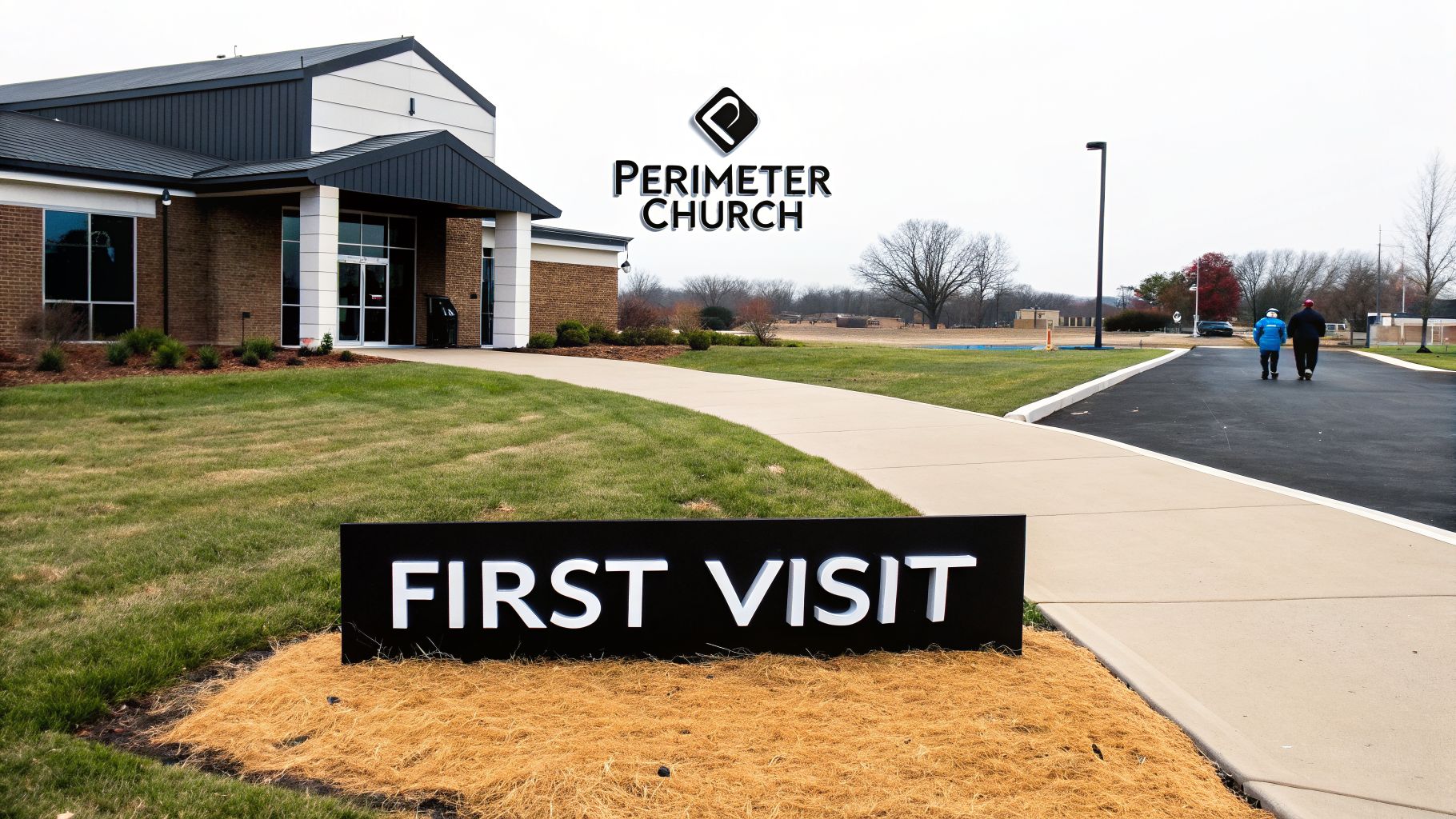 Exterior view of Perimeter Church building with a "FIRST VISIT" sign and two people walking.