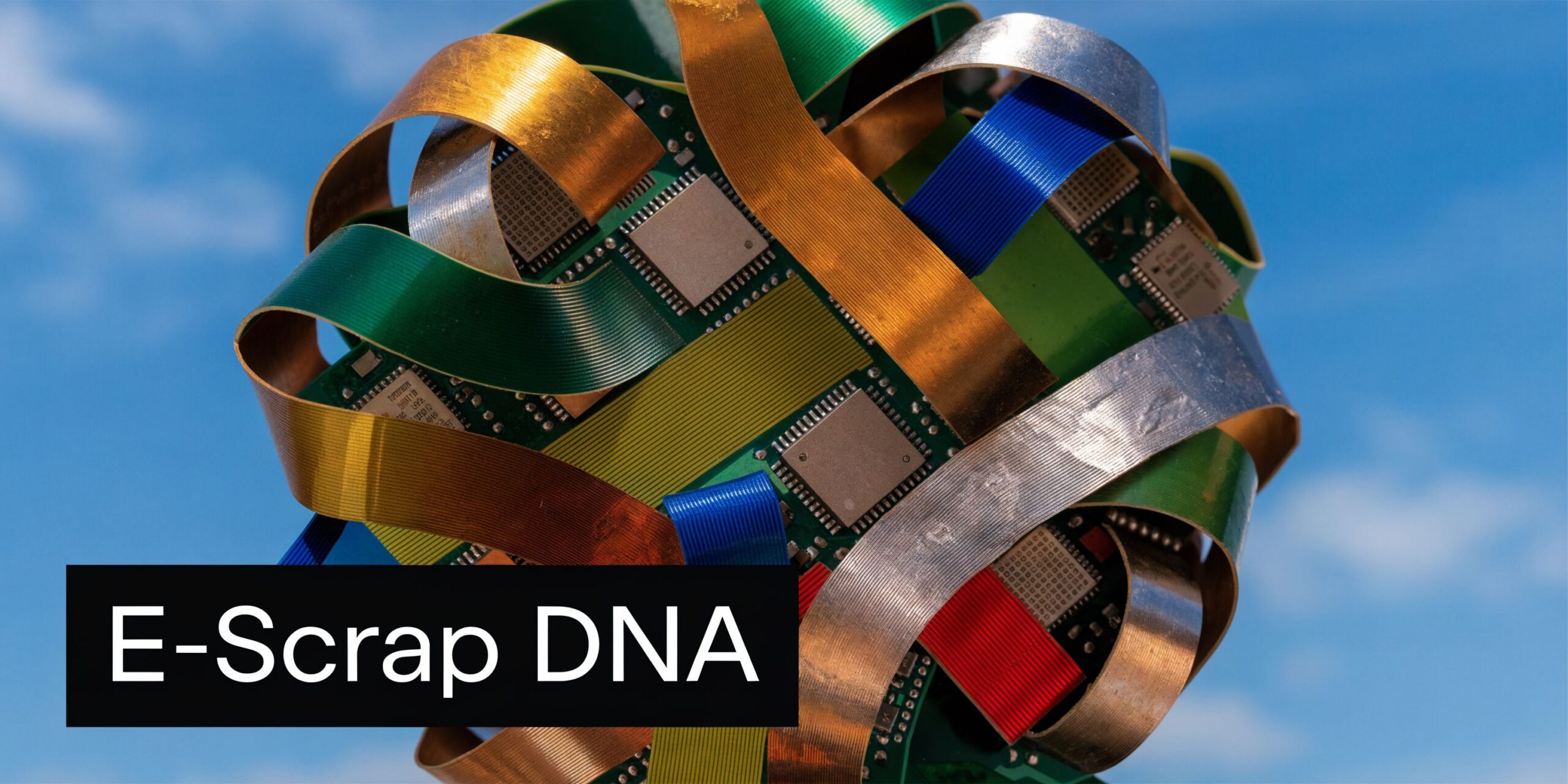 A complex spherical sculpture crafted from colorful electronic circuit boards and flexible metal ribbons against a blue sky.