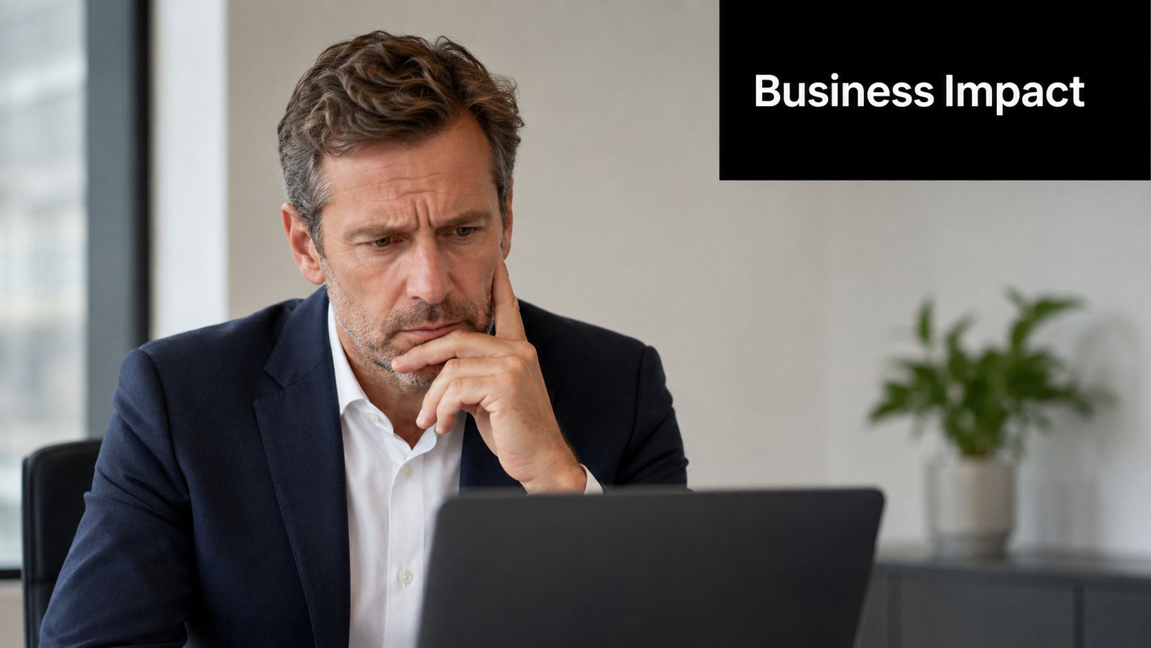 A concerned business executive reviewing data on a laptop in a modern office environment.